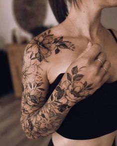 a woman with flowers on her arm and chest