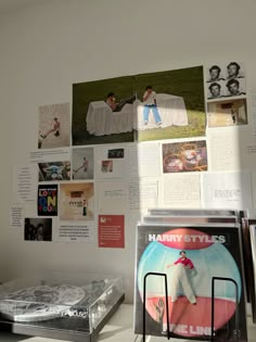 there are many pictures on the wall above the bed and in front of it is a record player