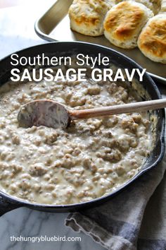 southern style sausage gravy in a cast iron skillet with biscuits on the side