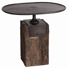 a wooden table with a metal plate on it's top and an iron base