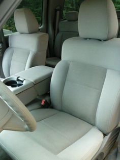 the interior of a car with white leather seats