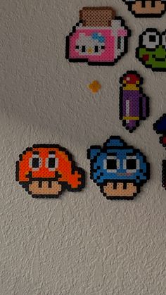 several pixelated video game characters are hanging on the wall in front of a mirror