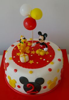 a birthday cake decorated with mickey mouse and friends