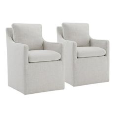 a pair of white chairs sitting next to each other