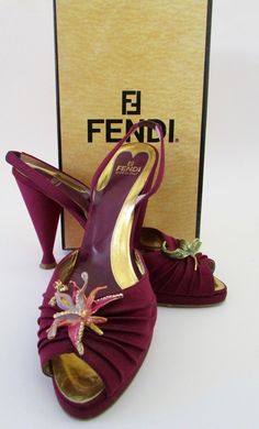 A stunning pair of matte fabric shoes with dimensional enamel orchid & leaf flowers, crystal embellishments. Comes with original box from Bergdorf Goodman. Original price $550. Overall very good condition. Each shoe has light black dots, hard to see unless closely inspected. Purple wine bodies. High heels but with front platform they are more like 3" tall. Size 9.5". Interior toe to heel length: 10.5". Width: 3". Heel: 4.5". Platform: 1". Signed confirmation on delivery. Paypal Payments Only Ple Unique Heels Classy, Flower Shoes Heels, Orchid Shoes, 90s Heels, Purple High Heels, Flower Heels, Purple Heels, Flower Shapes, Matte Fabric