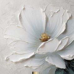 a large white flower sitting on top of a table