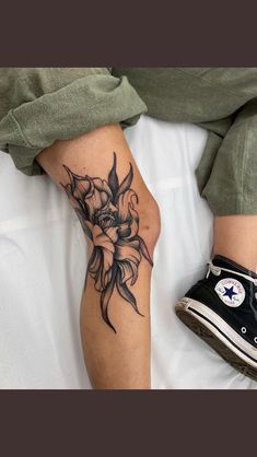 a person with a flower tattoo on their leg