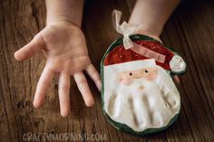 hand print keepsake craft with santa clause on it's back and hands in the air