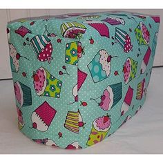 a blue and pink ottoman cover with cupcakes on it