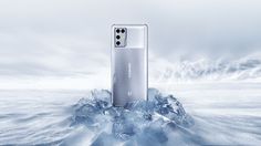 the new oneplus smartphone is floating on an ice - covered mountaintop in this artistic photo