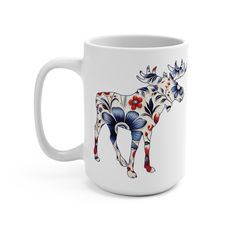 a white coffee mug with an image of a cow on it's front and side