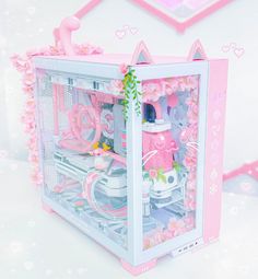 a pink and white doll house with lots of stuff in it's display case