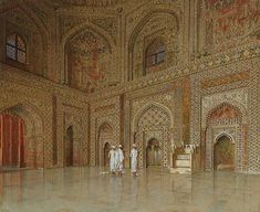 two men standing in an ornately decorated room with tile work on the walls and ceiling