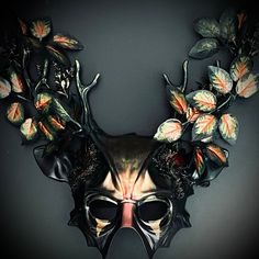 Forestry and earthy are three tones that give this Dark Oliver Green ,Forest Accent mask a graceful twist in contrast to the short horns. Branches with shiny, futuristic leaves complement the Dark Olive Green mask that is equipped with elf-like ears and deep grooves on the forehead. Forest Masquerade, Animal Masquerade, Deer Mask, Mask Ball, Green Mask, Ball Mask, Animal Mask, Party Mask, Mask Halloween