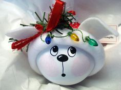 a white bear ornament with christmas lights on it's head