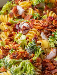 the pasta salad is loaded with broccoli, bacon, and other toppings