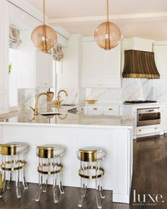 the instagram page on instagram com shows an image of a white kitchen with gold accents