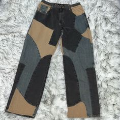 a pair of jeans with different colored patches on them