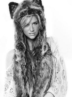 black and white photograph of a woman wearing a fur hat with hood over her head