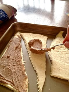 someone is spreading peanut butter on some food