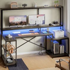 a computer desk with two computers on it