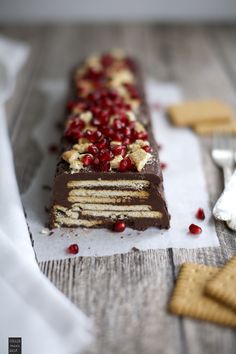 a piece of cake sitting on top of a table next to crackers and cranberries