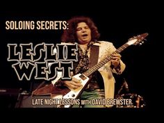 a man playing an electric guitar in front of a black background with the words legie west on it