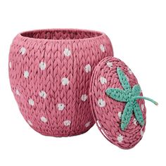 a pink basket with a green starfish on it