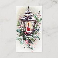 a christmas card with a lit candle and holly