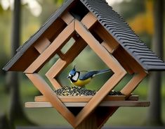 a bird feeder with a blue and yellow bird sitting on it's side in front of trees