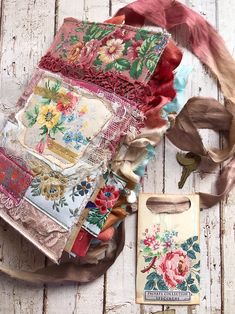 an assortment of fabric and other items on a wooden table with white boards in the background