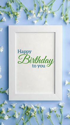 a white frame with the words happy birthday to you on it and flowers around it