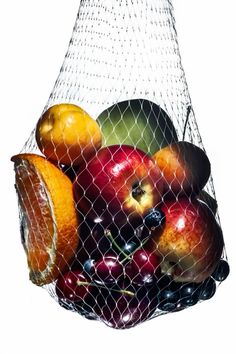 a mesh bag filled with assorted fruit