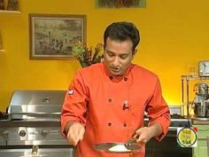 a man in an orange chef's coat preparing food