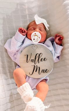 a baby is holding a sign that says vale mae