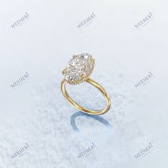 a yellow gold ring with a pear shaped diamond in the center on a white background