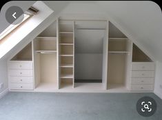 an attic bedroom with built - in shelving and closets