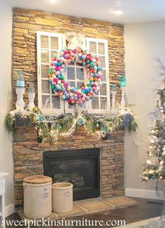 a fireplace decorated for christmas with wreaths and balloons on the mantel above it