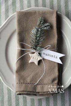 a place setting with napkins and christmas decorations