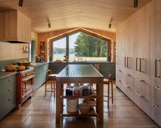 a large kitchen with wooden cabinets and an island in the middle, along with lots of counter space