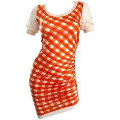 Sexy vintage 90s MOSCHINO CHEAP AND CHIC orange and white gingham asymmetrical bodcon dress! Features a vibrant orange, mixed with white. Short sleeves features perforated cut-outs on each sleeve. Asymmetrical hem, with gathers up the left side. Simply slips over the head, and stretches to fit. Flattering ruching detail, along with the stretch make this a sure winner for multiple sizes. Looks great belted or alone, and from day to evening. The pictured Gisueppe Zanotti belt is also available in Orange White Outfit, Chic White Dress, Orange Cocktail Dresses, Orange Gingham, Red Era, Vintage Moschino, Chic Cocktail Dress, Moschino Dress, Cocktail Dress Vintage