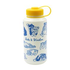 a blue and white water bottle with dogs on it's side, next to a yellow lid