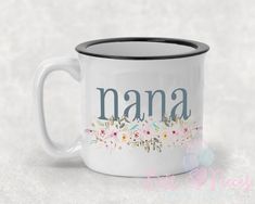 a white coffee mug with the word nana painted on it and flowers in front