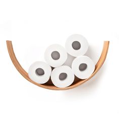 several rolls of toilet paper in a wooden holder