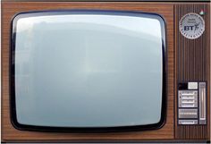 an old fashioned television sitting on top of a wooden table