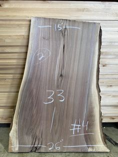 a piece of wood that has been cut in half and is marked with white numbers