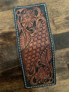 Hand crafted leather money clip wallet has a tooled floral design at each end and a basket weave pattern through the middle. when folded it measures approximately 3 inches wide, 3.75 inches long and around a half inch thick empty. It has Two  pockets that can hold several credit card and a spring clip to hold your paper money. The wallet is handmade using 100 percent top grain cowhide leather as used in saddle construction. It is dye brown, with a black background, edges are dyed black and burnished to a smooth finish, with a  Light brown antique  applied to highlight the tooling. Inside is natural finished top grain leather. This minimalist wallet is a perfect size for going light and works great in your front or back pocket. Made in Alvarado Texas.   This wallet is made to order, please Leather Money Clip, Leather Money Clip Wallet, Basket Weave Pattern, Leather Money Clips, Money Clips, Leather Carving, Weave Pattern, Clip Wallet, Minimalist Wallet