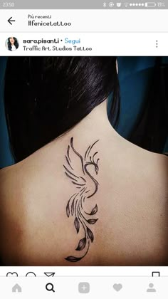 the back of a woman's neck with a bird tattoo on it