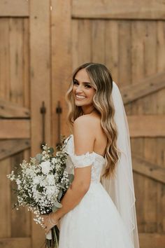 a woman in a wedding dress holding a bouquet