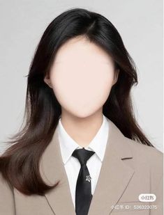 a woman wearing a suit and tie with long dark hair in front of a white background